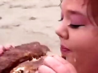 Enormous lifeguard whores eat food on the beach